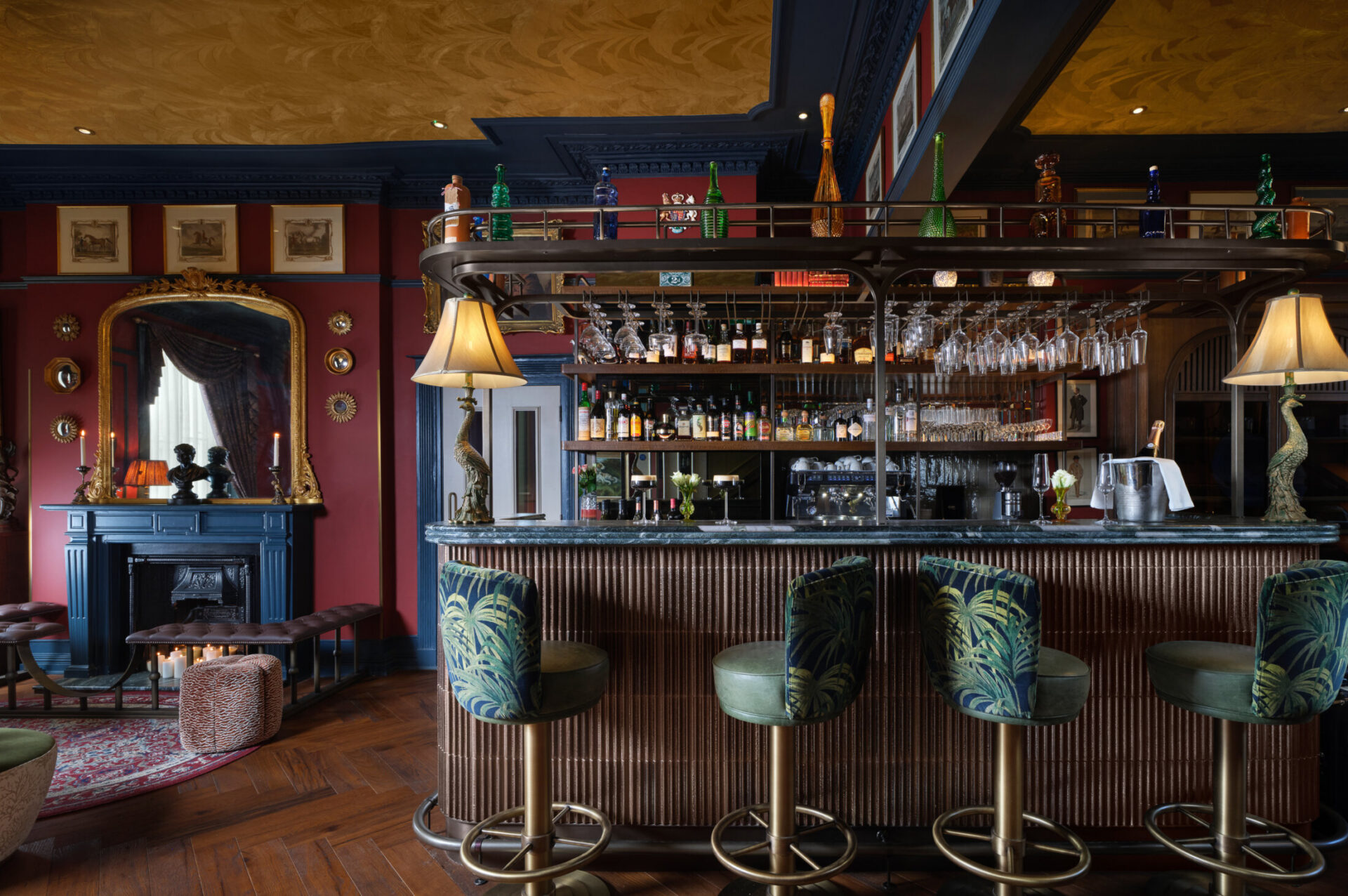Ottie's Salon at bertrand's townhouse with dark green high chairs and gold accents