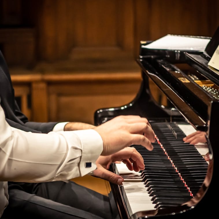 two people playing the piano