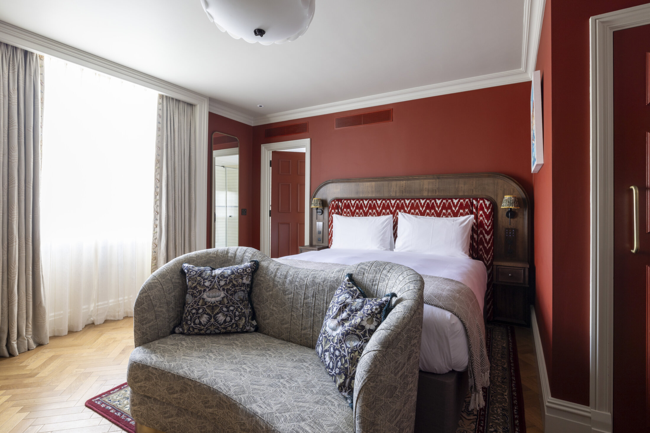 large hotel bedroom with red walls
