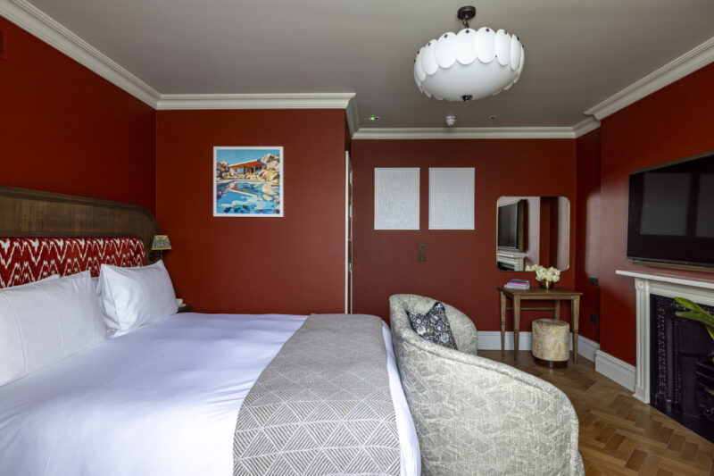 large hotel bedroom with flatscreen tv