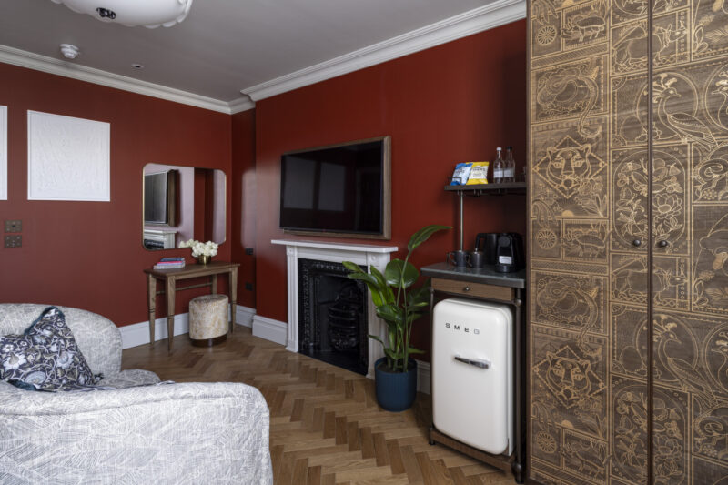 large hotel bedroom with red walls