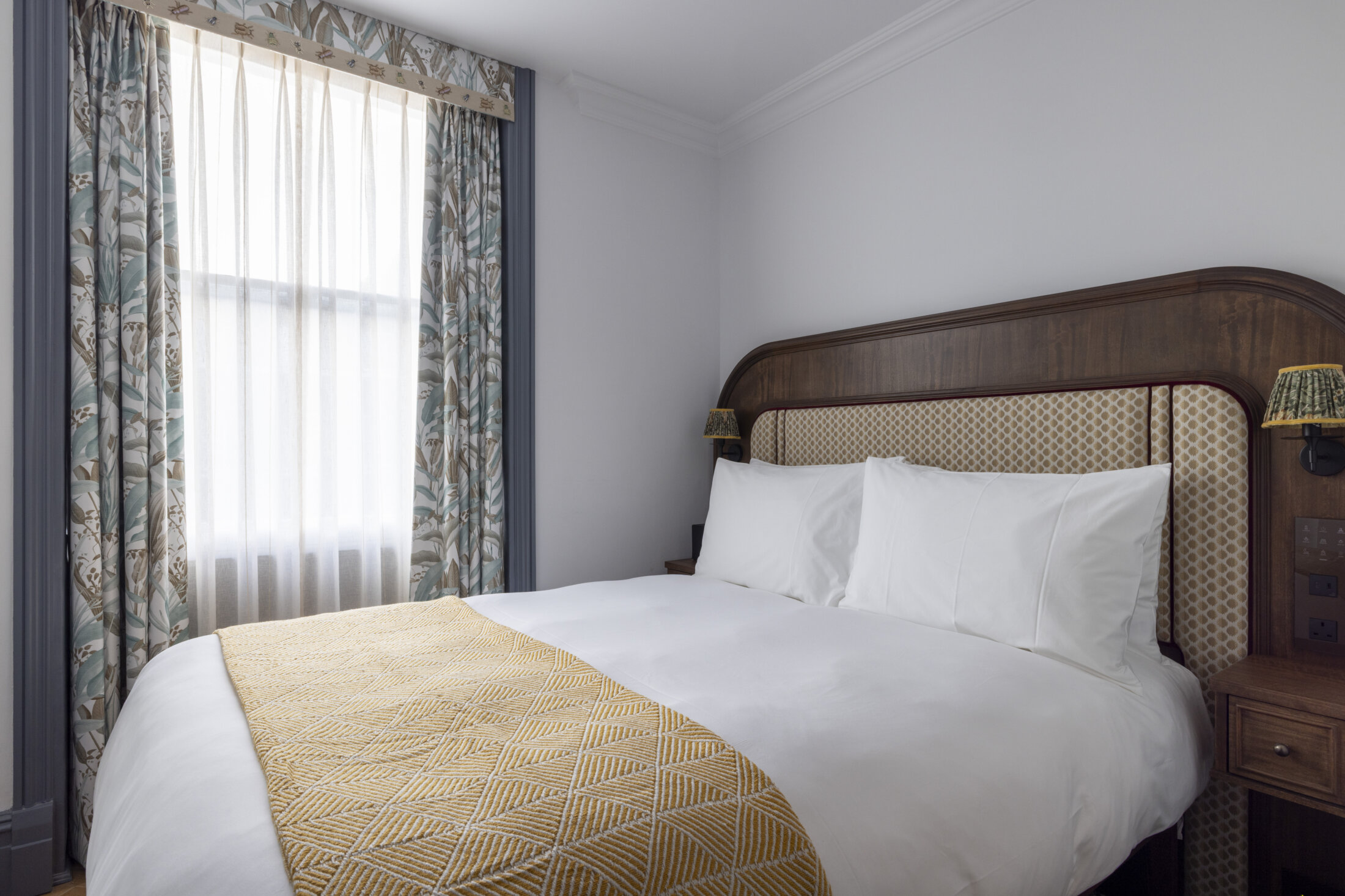 hotel bedroom with yellow triangle throw