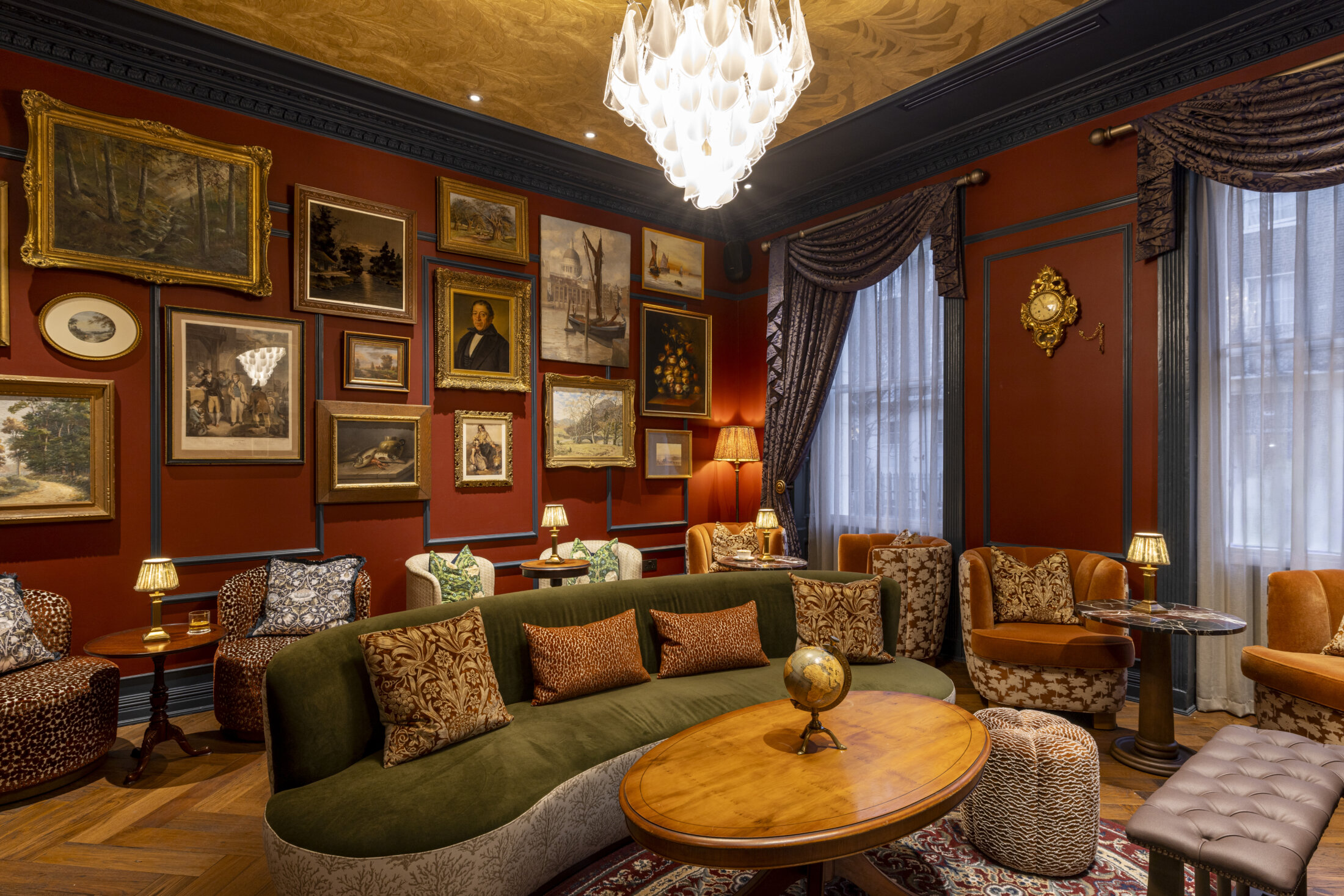 otties salon at bertrands townhouse comft green sofa and gold framed ornate photo frames