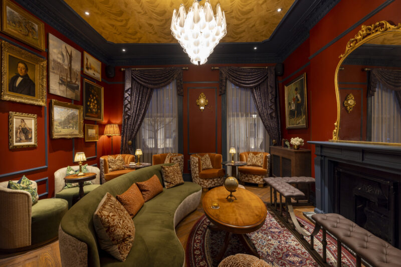 otties salon with gold frame images and green sofa