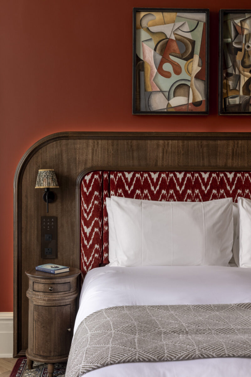 large hotel bedroom with red walls