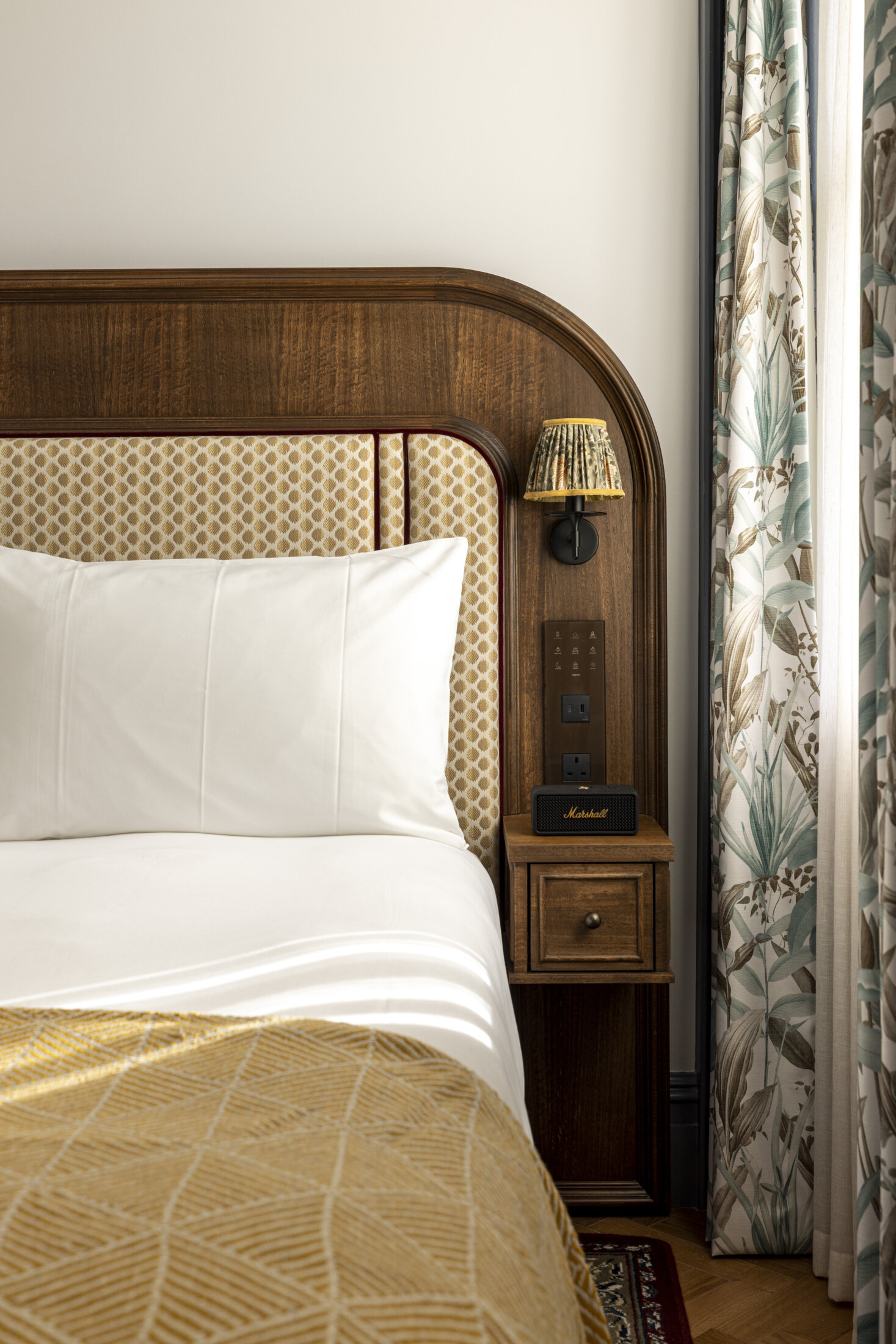 hotel bedroom with yellow throw