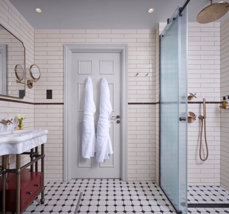 large hotel bathroom with large waterfall showerhead
