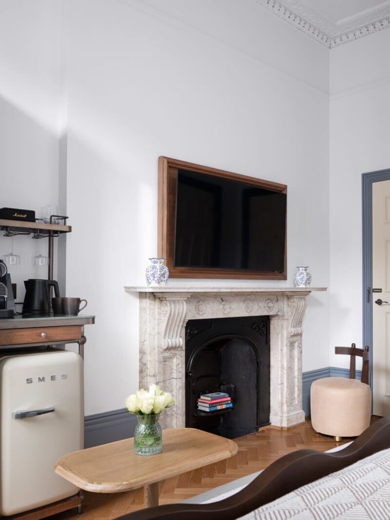 large tv mounted in double bedroom hotel