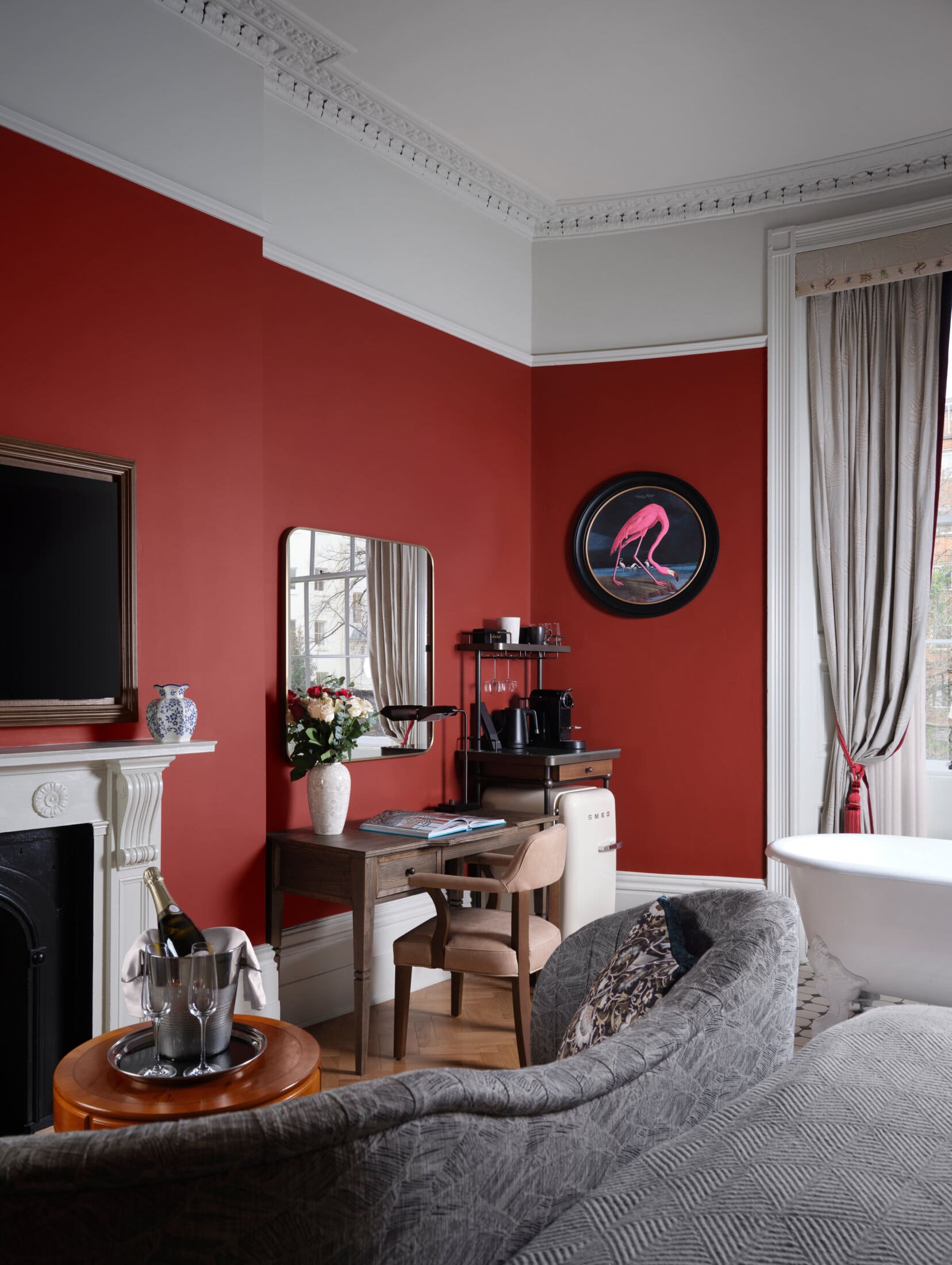 large suite hotel room with dark red walls