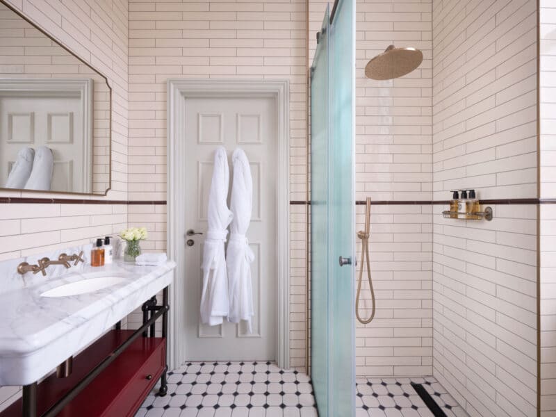 large hotel bathroom with large waterfall shower head