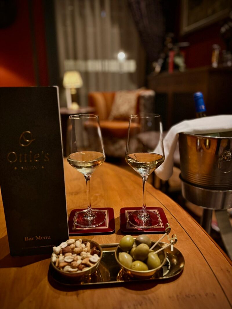 two glasses of wine at otties salon with olives and nuts