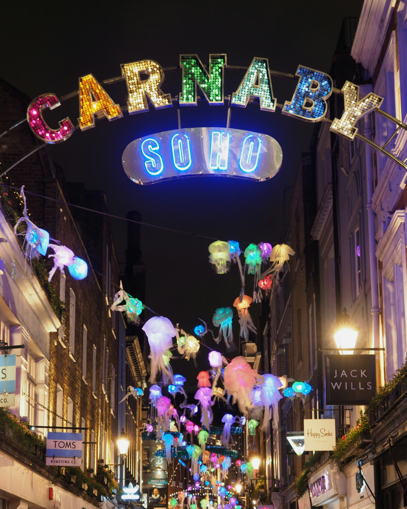 Carnaby Street in Soho lit up with decorations in the night
