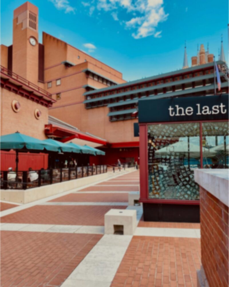 The British Library building on a sunny day with blue skies above
