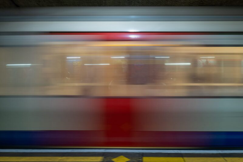 A train rushing past the camera in a London Underground Station.