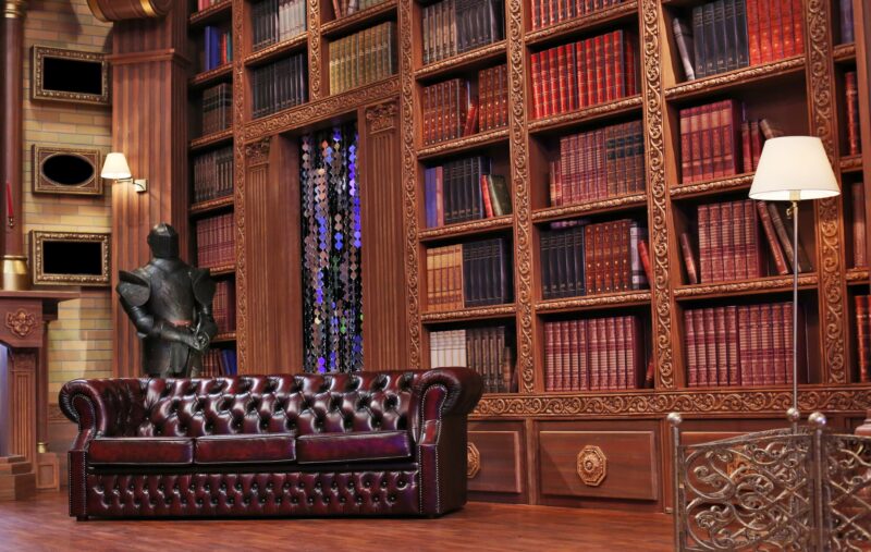 Several bookcases and a leather sofa inside the British Library
