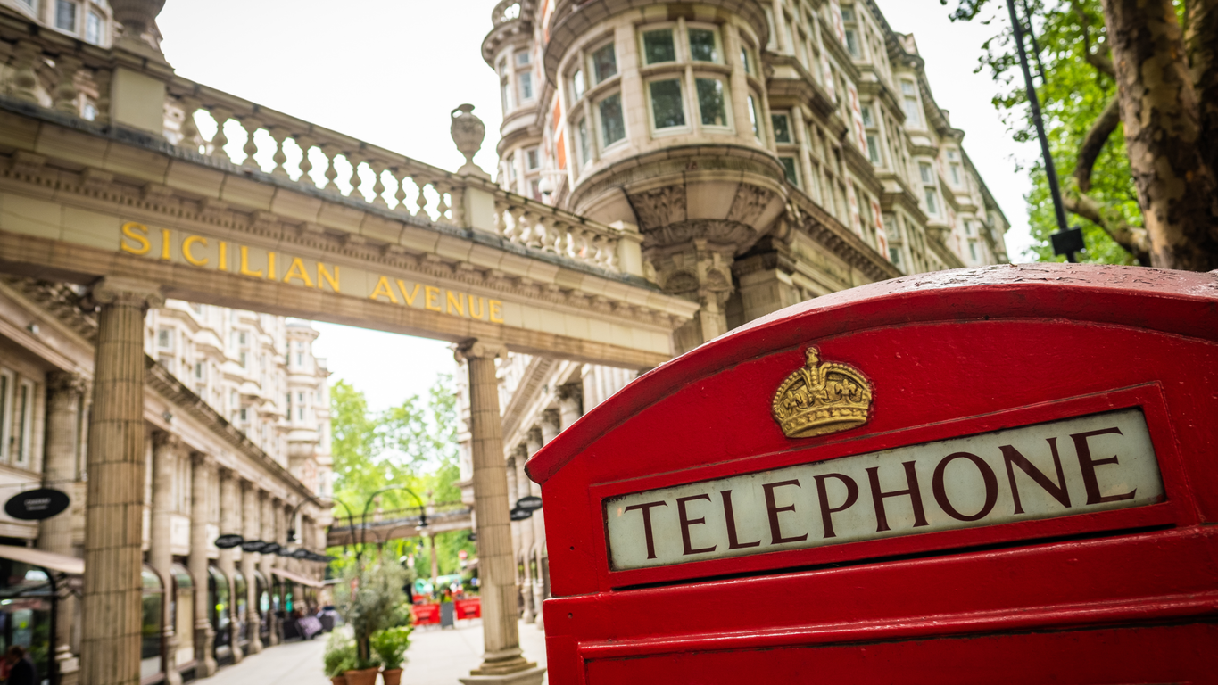 A telephone box and street in Bloomsbury on a bright day.