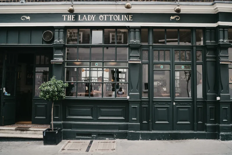 The Lady Ottoline pub, a green building with lots of small windows.